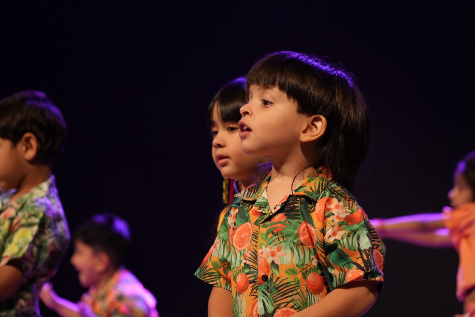 Children performing on stage at TrottersStop Montessori